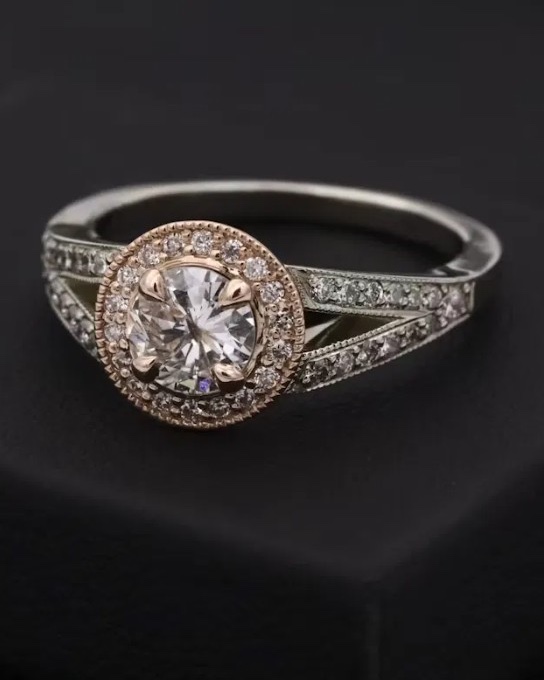 Diamond halo ring with a rose gold surround and diamond-set white gold shoulders